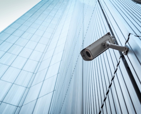 Surveillance camera on side of tall commercial building